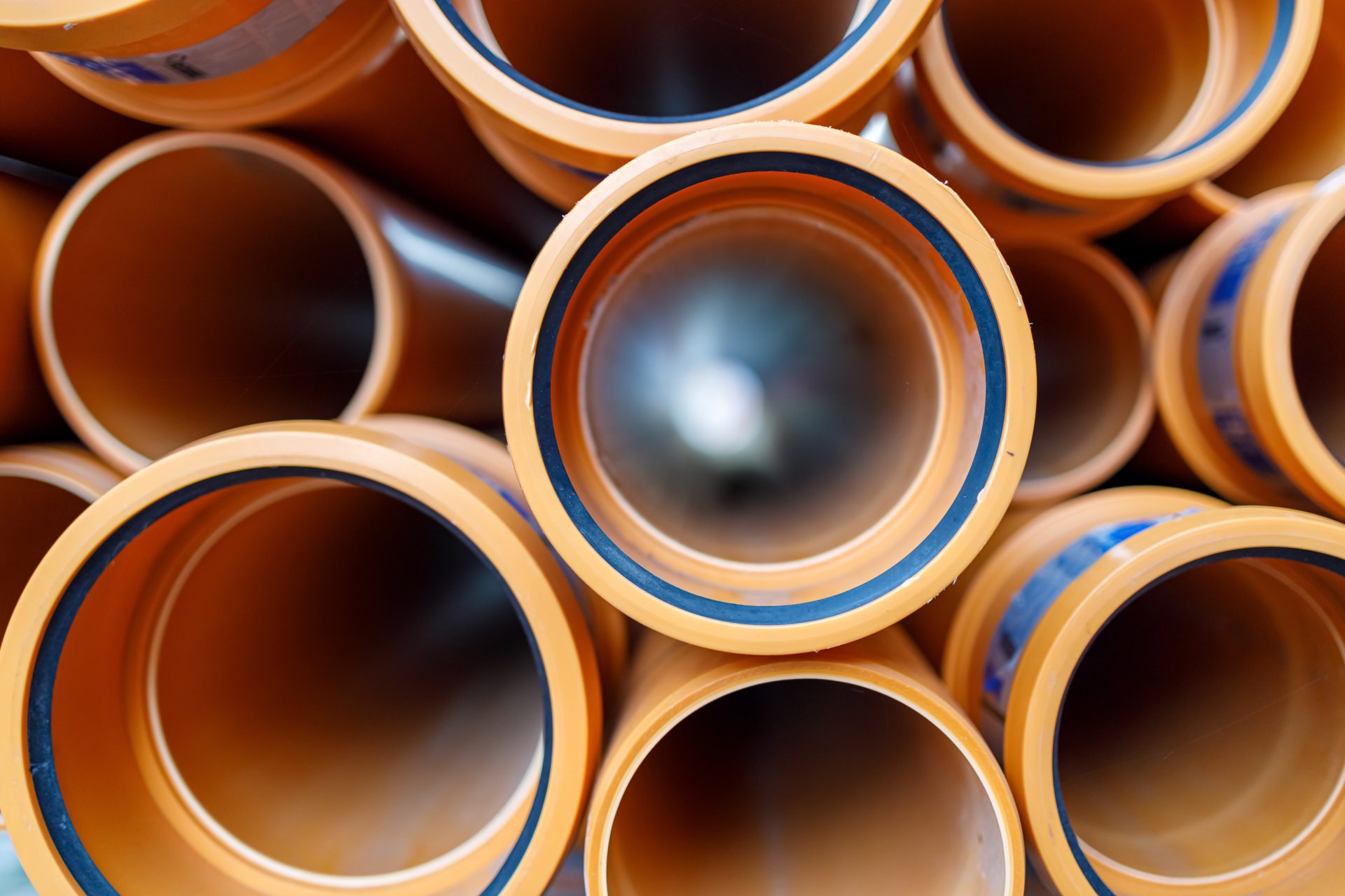 Close up of orange sewer pipes on a construction site