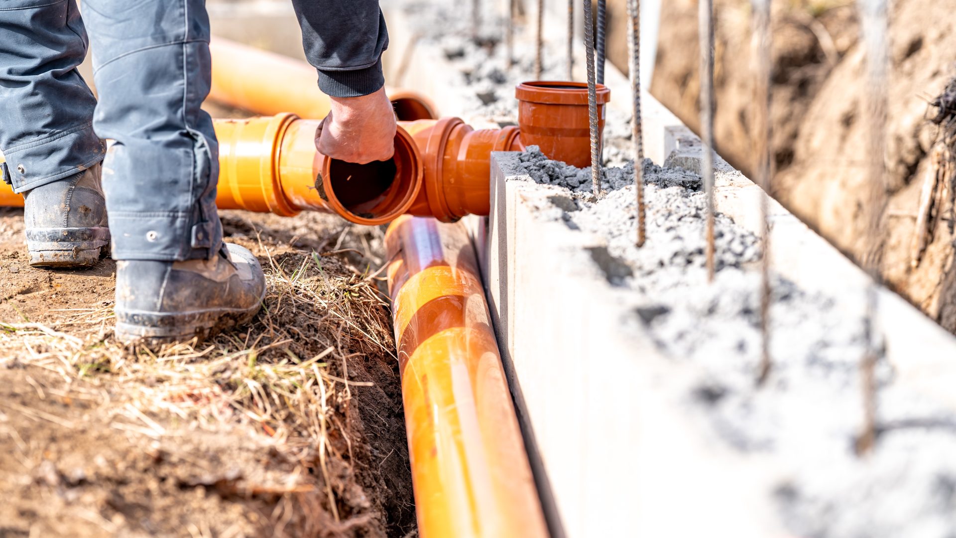 Avalon Rooter installing new sewer line pipe underneath new home under construction