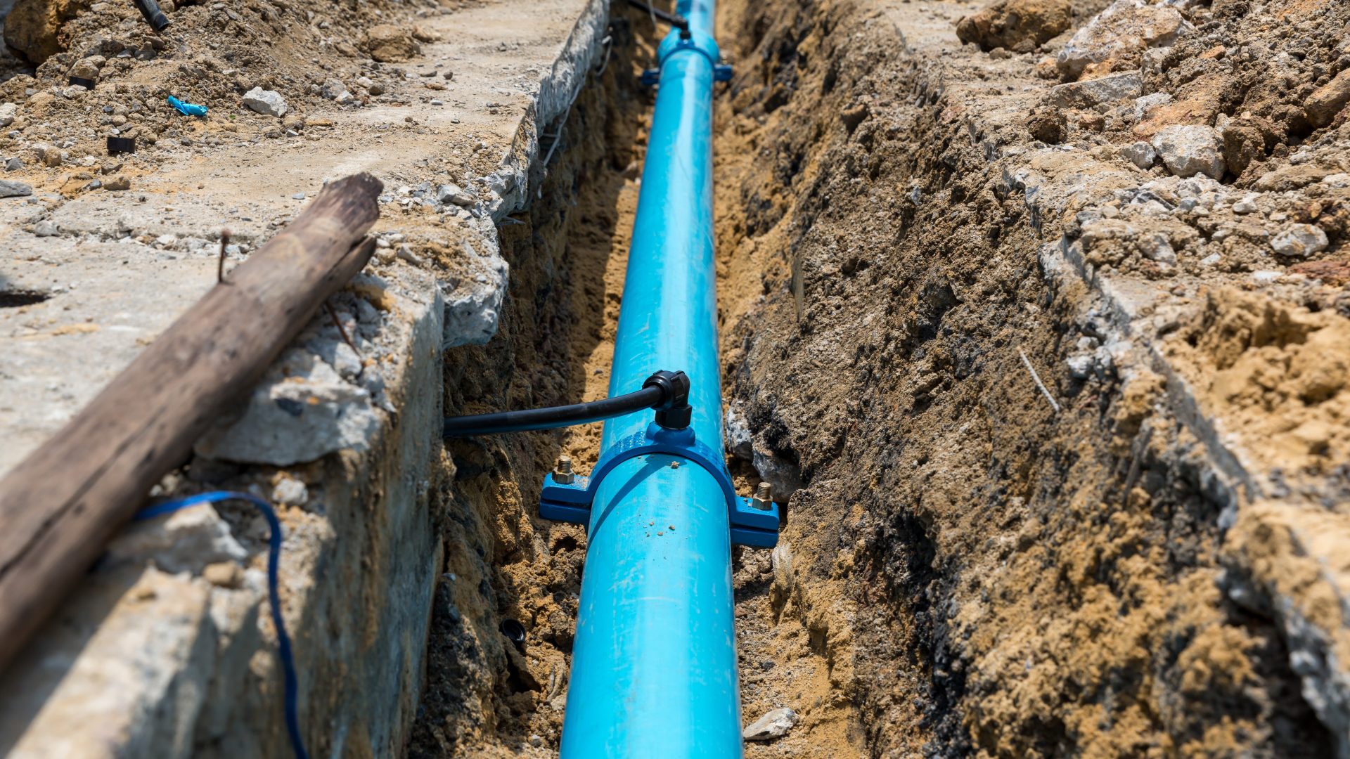 Bright blue sewer line excavation site