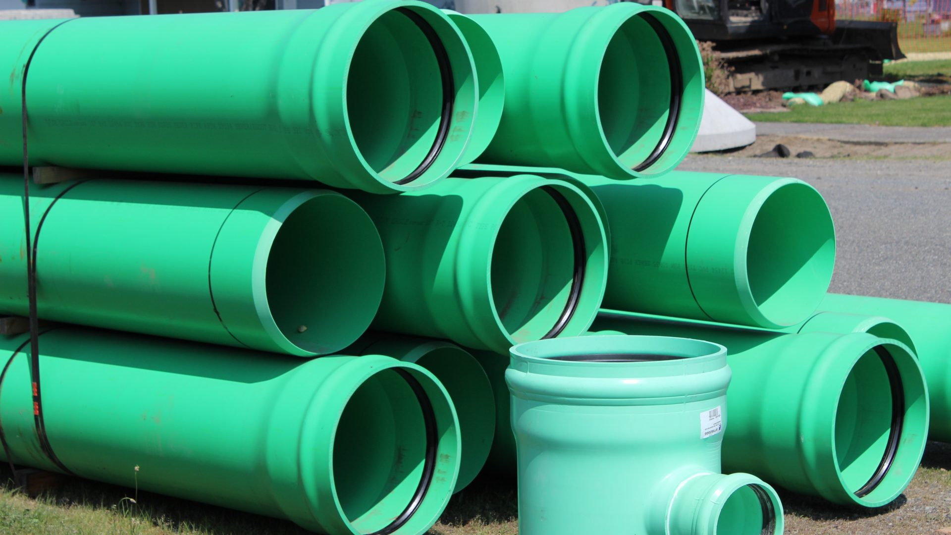 Stack of green sewer pipes