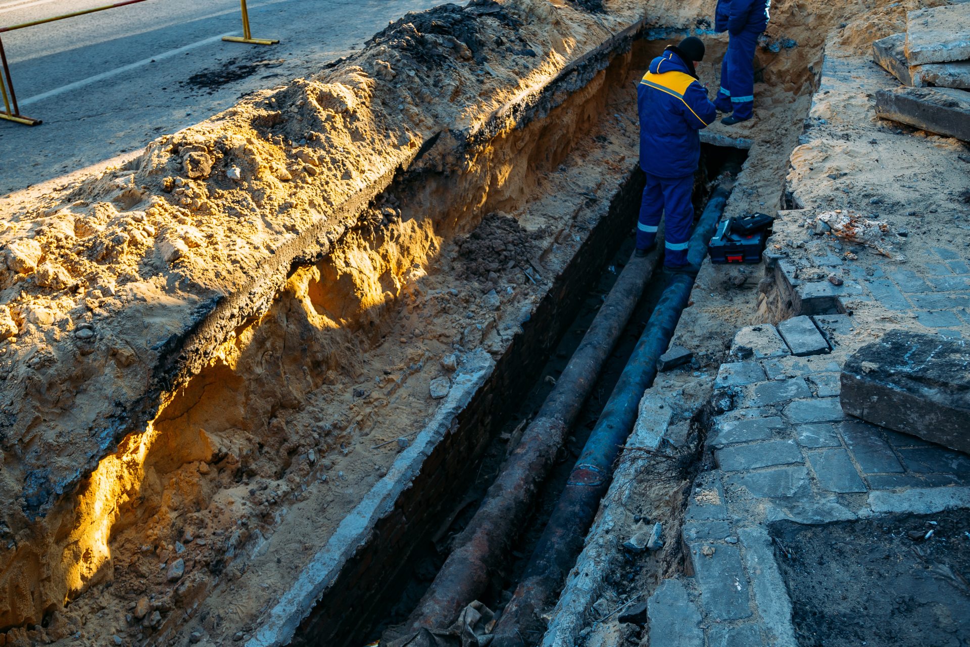 Technicians working on a sewer line replacement.