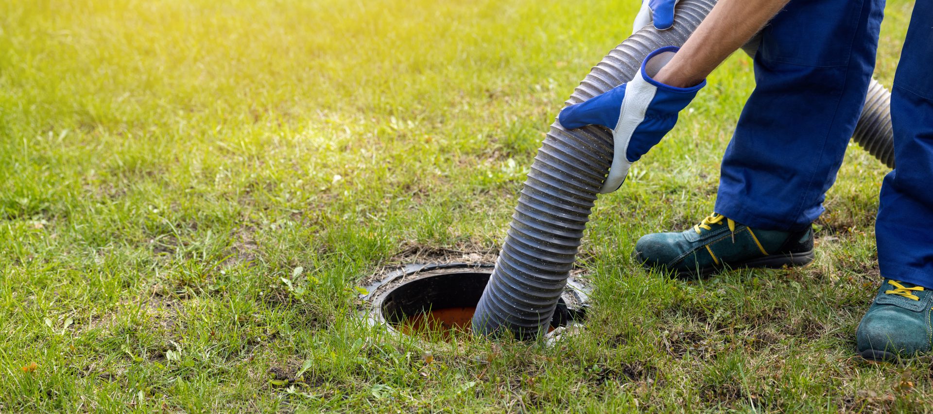 A technician pumping a septic tank.