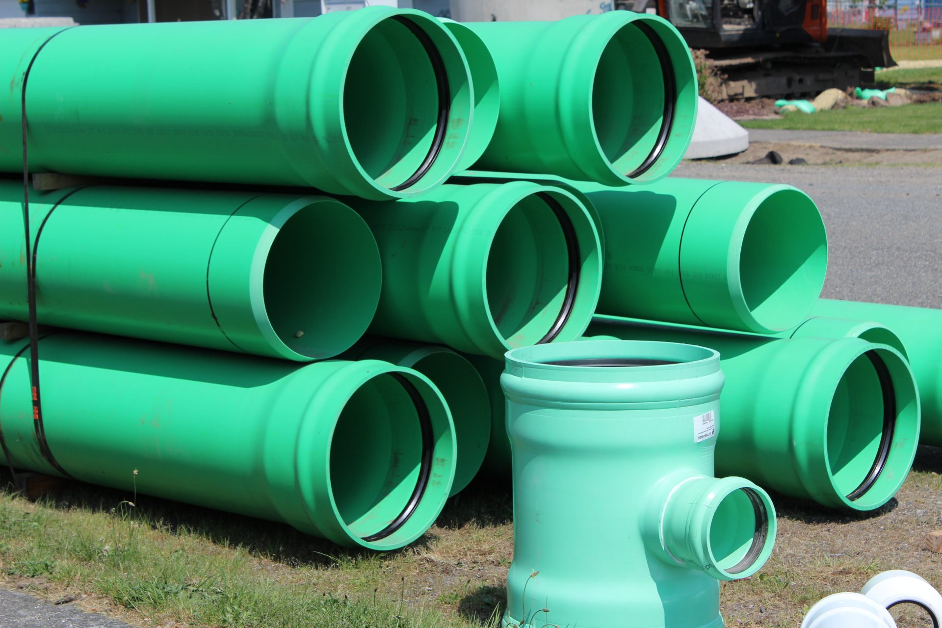 A stack of sewer pipes waiting to be installed.